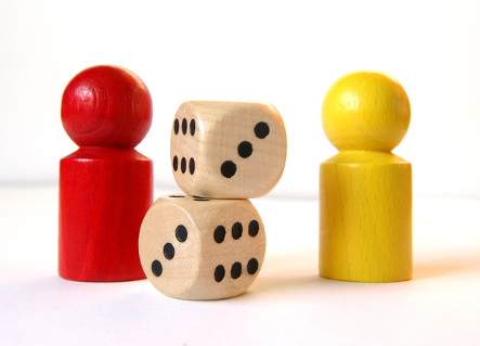 An image of two board games pieces and two die.